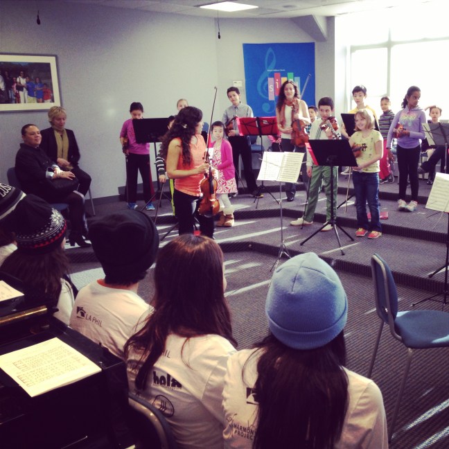 YOLA musicians look on as Boston String Academy musicians perform Vivaldi for them.